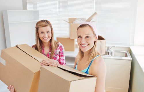 Packed storage unit with labeled boxes and wrapped furniture